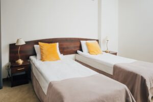 dwa łóżka pojedyncze, szafki nocne po bokach